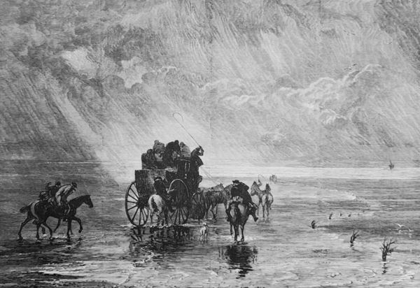 Engraving in black ink showing a mail coach with outriders on the roof, front and back, crossing the sands in stormy weather as the tide comes in. A guide on a horse with a dog can be seen at the front right of the coach beside a line of path markers called 'brobs' made of laurel branches stuck into the sand. 